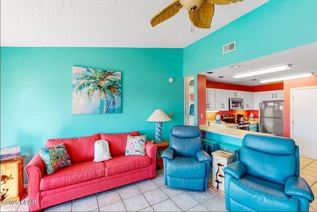 tiled living room with ceiling fan, lofted ceiling, and a textured ceiling