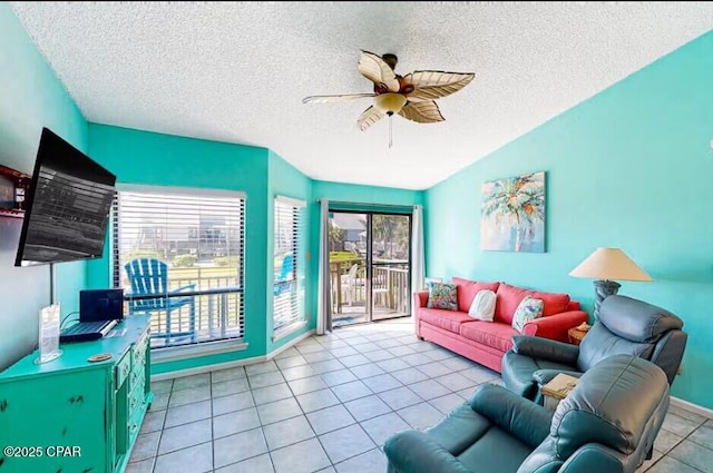 tiled living room with a textured ceiling and ceiling fan