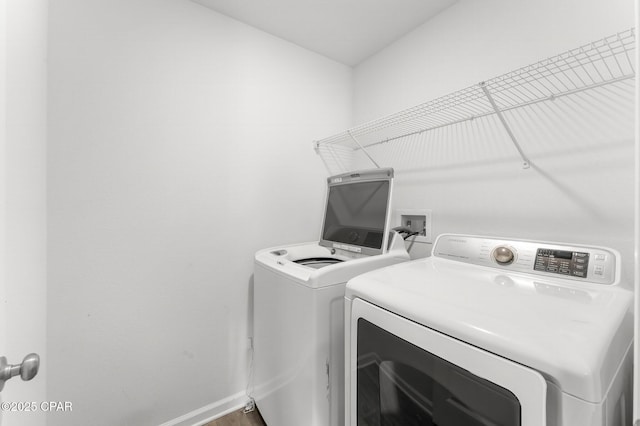 clothes washing area with washer and clothes dryer