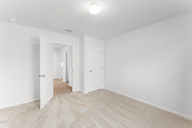 unfurnished bedroom with light colored carpet