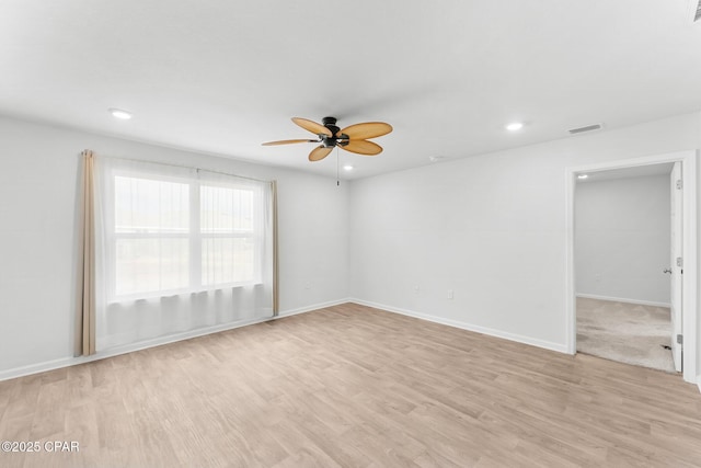 empty room featuring ceiling fan and light wood-type flooring