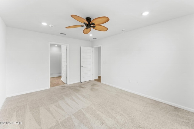 unfurnished bedroom featuring ceiling fan, ensuite bathroom, and light carpet