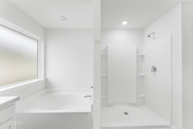 bathroom featuring vanity and separate shower and tub