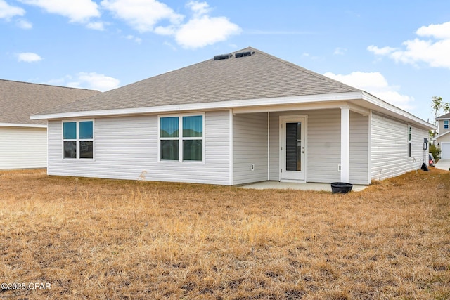 rear view of property with a yard and a patio