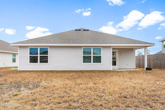 back of property featuring a lawn