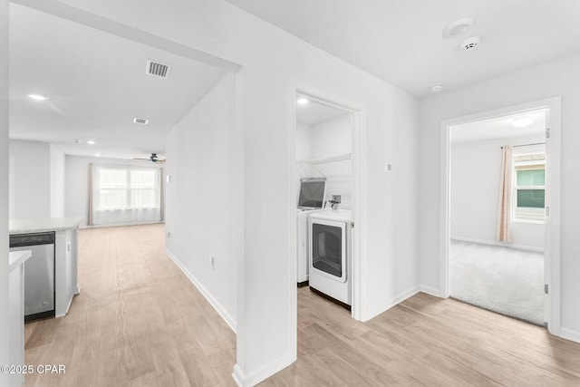 hall featuring washer and dryer and light hardwood / wood-style flooring