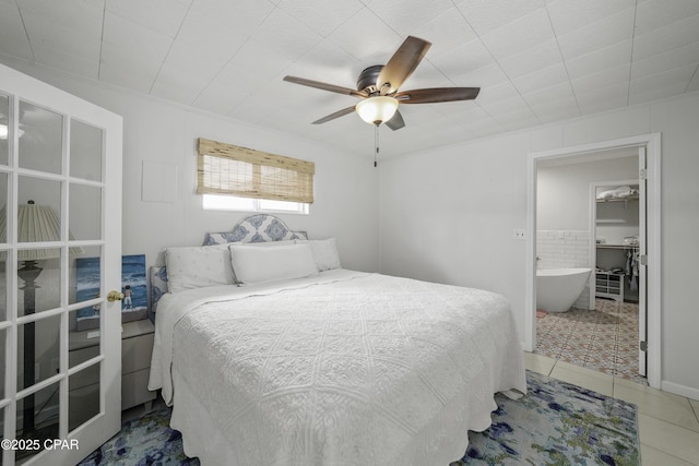 tiled bedroom featuring ceiling fan