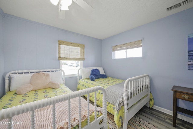 bedroom featuring dark wood-type flooring and ceiling fan