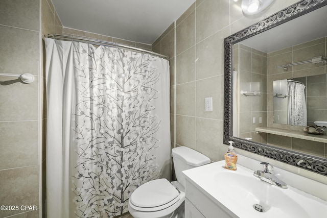 bathroom with tile walls, vanity, a shower with curtain, and toilet