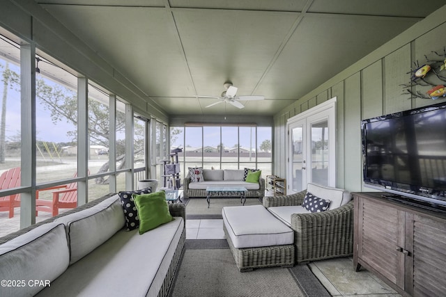 sunroom / solarium featuring french doors and ceiling fan