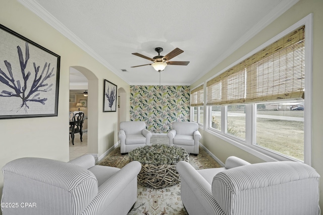 living room with ceiling fan, ornamental molding, and light tile patterned floors