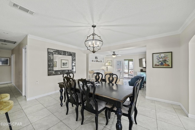 tiled dining space featuring ornamental molding and a textured ceiling