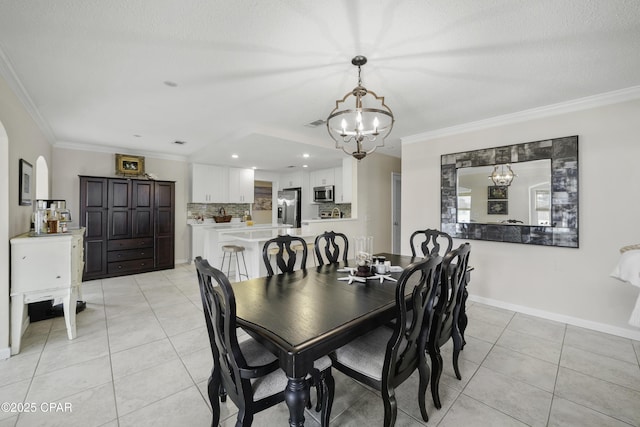 dining room with a notable chandelier, crown molding, and light tile patterned flooring