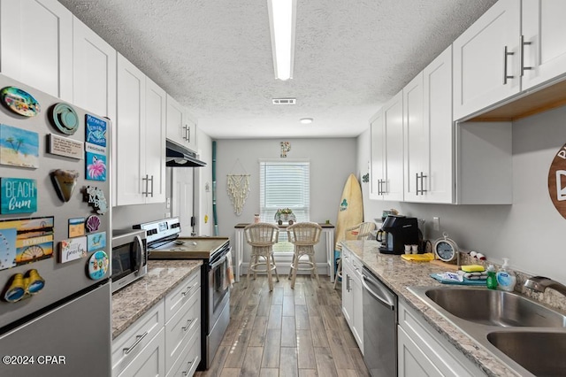 kitchen with white cabinetry, sink, and appliances with stainless steel finishes