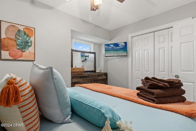 bedroom with ceiling fan and a closet