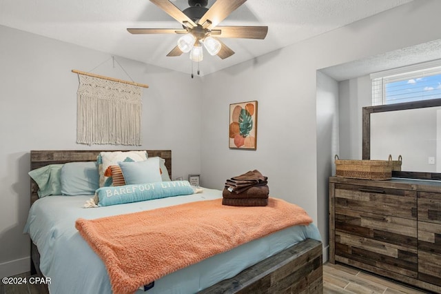 bedroom with light hardwood / wood-style floors and ceiling fan