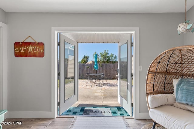 doorway with french doors and light hardwood / wood-style flooring