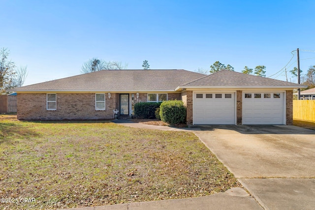 ranch-style house with a garage, concrete driveway, fence, a front lawn, and brick siding