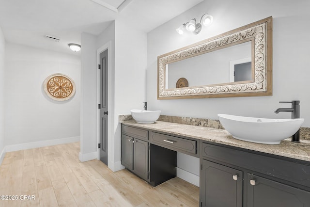 bathroom featuring vanity and hardwood / wood-style floors