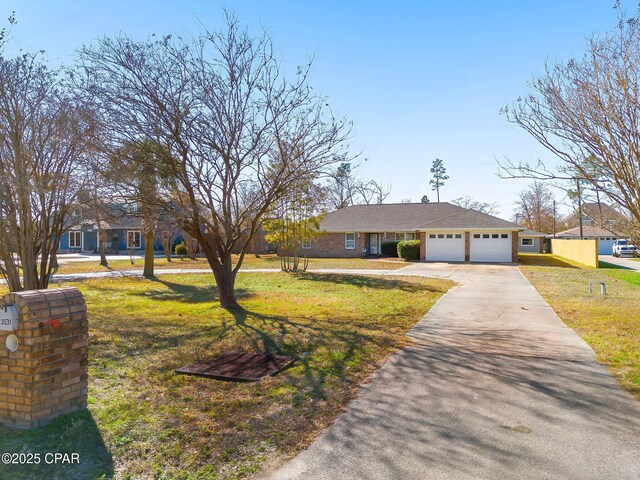 ranch-style home with a garage and a front lawn