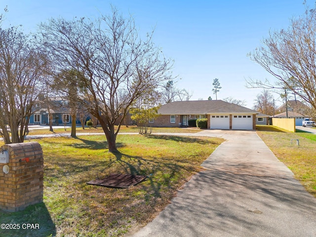 view of front of house with a garage, a front lawn, and concrete driveway