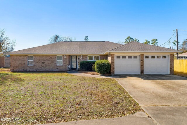 3531 Florida Ave, Panama City, FL 32405 - ranch-style house featuring a garage, brick siding, driveway, and roof with shingles