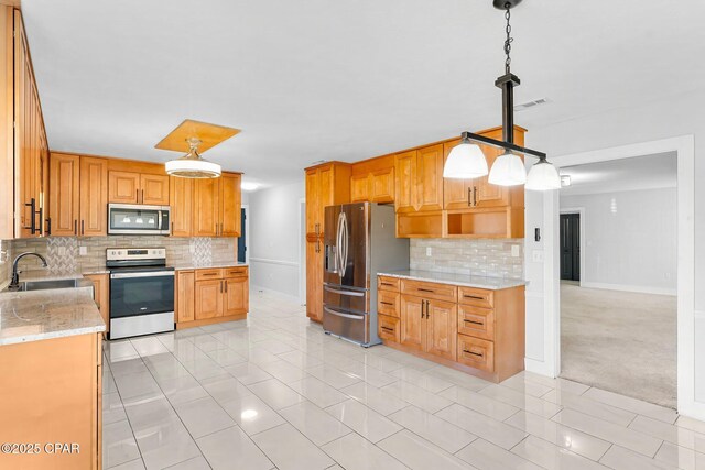 3531 Florida Ave, Panama City, FL 32405 - kitchen featuring stainless steel appliances, backsplash, light stone countertops, and a sink