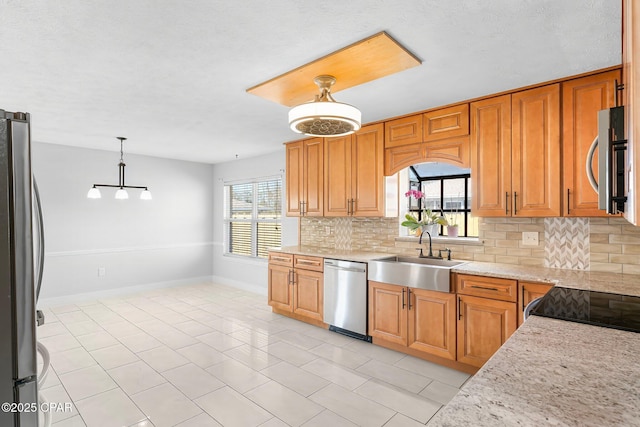 3531 Florida Ave, Panama City, FL 32405 - kitchen featuring appliances with stainless steel finishes, a sink, backsplash, and hanging light fixtures