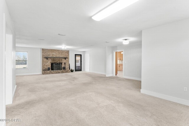 3531 Florida Ave, Panama City, FL 32405 - unfurnished living room featuring carpet floors, a brick fireplace, and baseboards