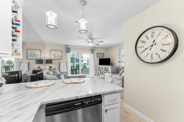 kitchen with pendant lighting, white cabinetry, dishwasher, ceiling fan, and light hardwood / wood-style floors