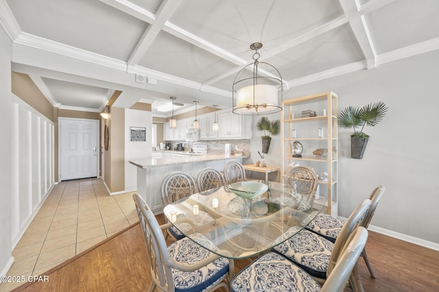 dining room with baseboards, coffered ceiling, and light wood finished floors