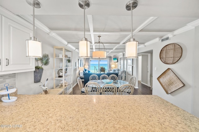 kitchen featuring visible vents, white cabinets, coffered ceiling, ornamental molding, and light countertops