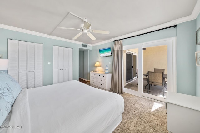 bedroom with visible vents, ceiling fan, ornamental molding, carpet flooring, and multiple closets