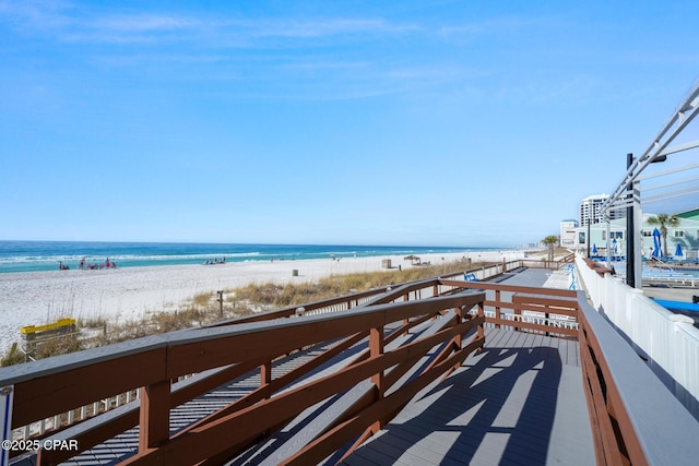 balcony with a water view and a beach view