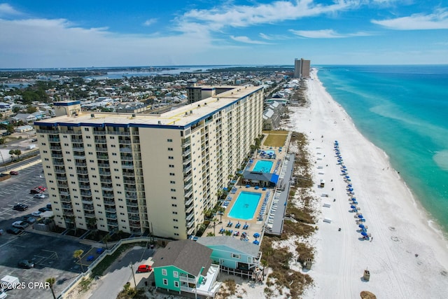 bird's eye view featuring a water view, a view of city, and a beach view