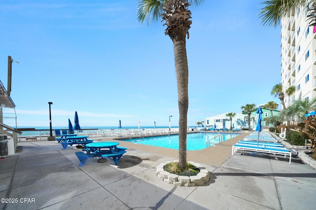 community pool with a patio area