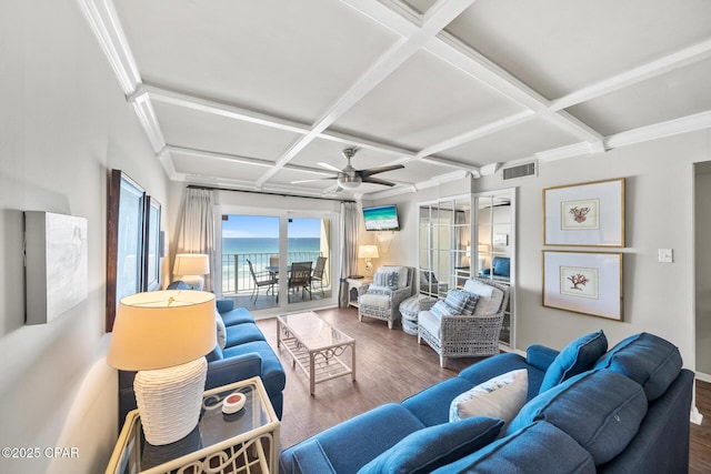 living area with visible vents, coffered ceiling, a ceiling fan, wood finished floors, and beam ceiling