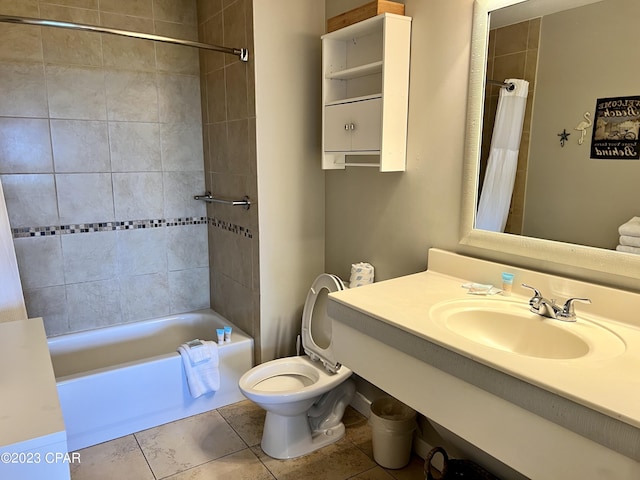 bathroom with tile patterned floors, a sink, toilet, and shower / tub combo with curtain