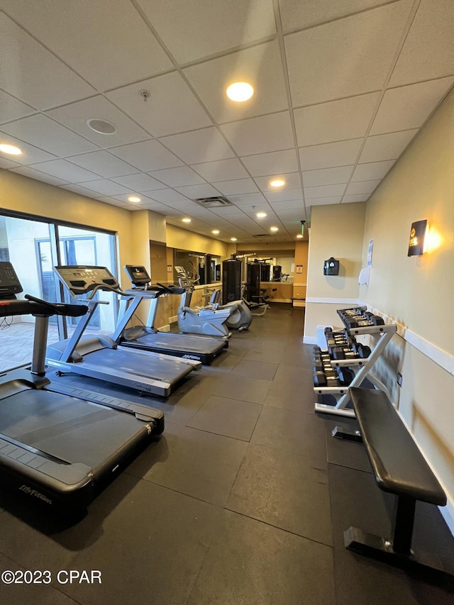 workout area featuring a paneled ceiling and visible vents