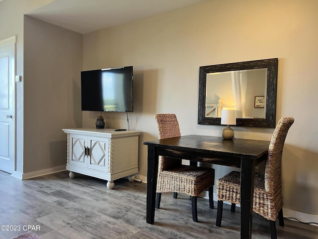 dining room with baseboards and wood finished floors