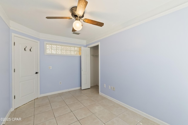 unfurnished bedroom featuring light tile patterned floors, a closet, a ceiling fan, visible vents, and baseboards