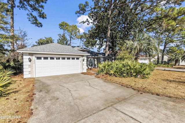 ranch-style house featuring roof with shingles, driveway, stucco siding, and a garage