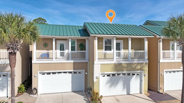 view of front of home with a balcony and a garage