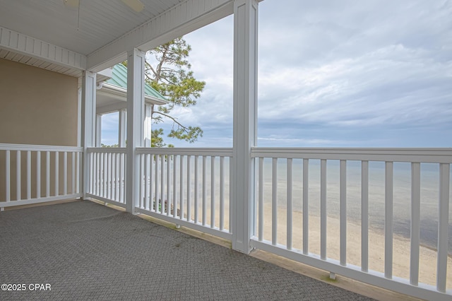 unfurnished sunroom with ceiling fan