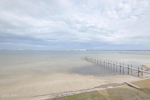 dock area with a water view and a view of the beach