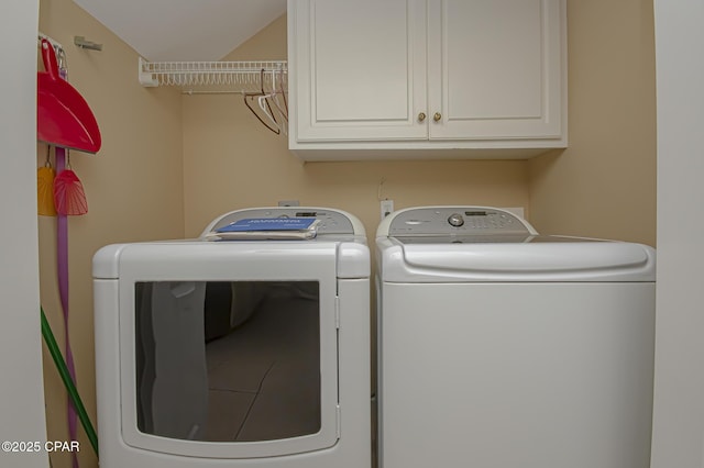 washroom featuring cabinets and washer and dryer