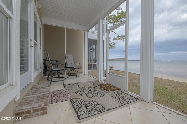 sunroom / solarium with a water view