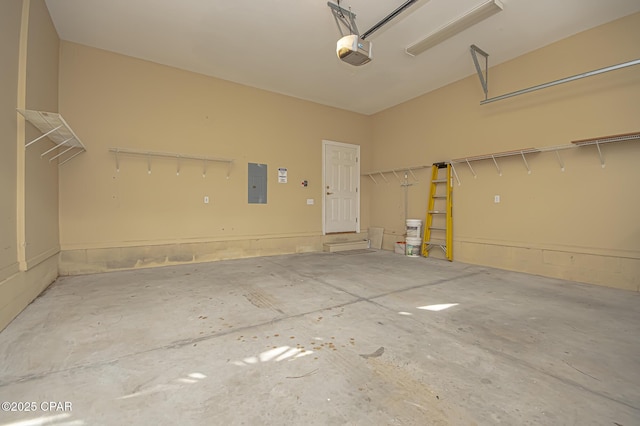 garage with a garage door opener and electric panel