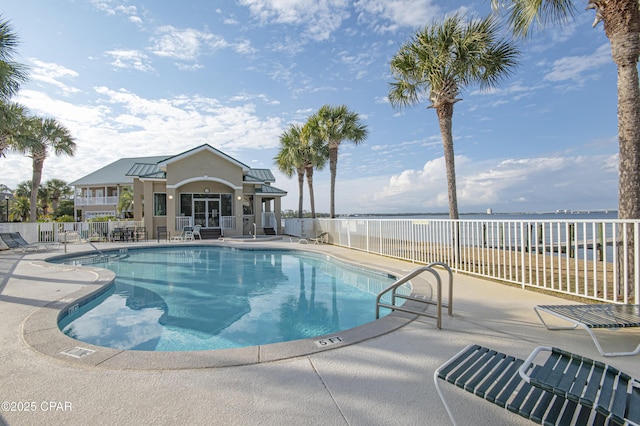 view of pool featuring a patio and a water view