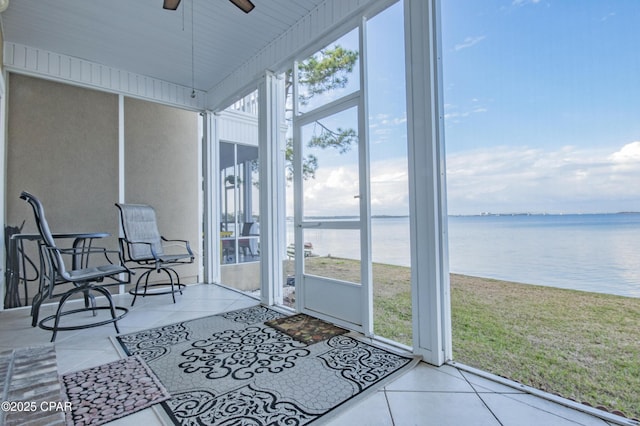 sunroom featuring a water view and ceiling fan